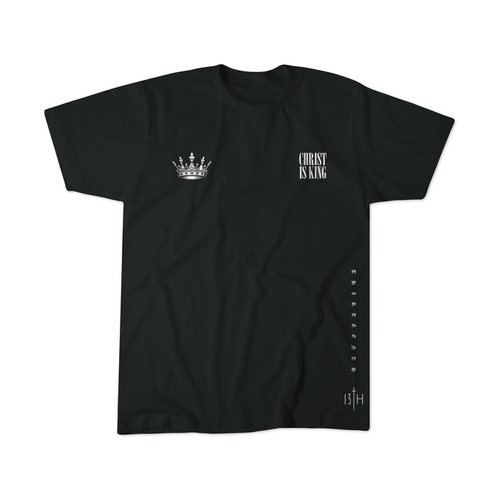 The 13th Christ is King Premium Tee is a black shirt with a white crown graphic on the left chest, "CHRIST IS KING" text on the right, vertical "Christ" along the right side, and "13TH" with a cross near the bottom hem.