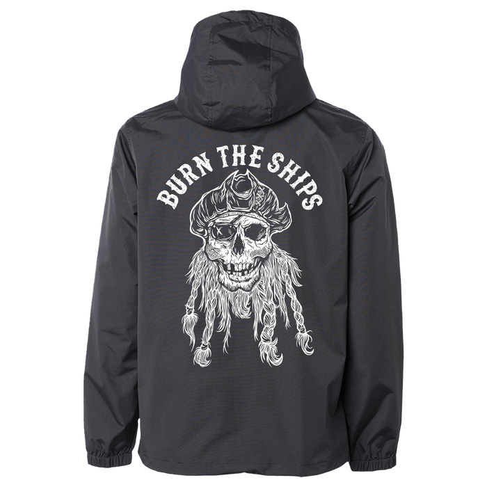 The Relentless Betrayal Burn the Ships Pullover Rain Jacket features a pirate skull graphic with a hat and beard on the back, boldly arched with BURN THE SHIPS. Its unisex and enhanced by a water-resistant coating for style and protection.
