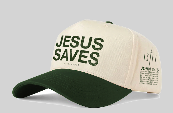 The 13th Jesus Saves Ivory Snapback is a beige and dark green cap with "JESUS SAVES" on the front, John 3:16, a Bible verse, and cross symbols on the side.