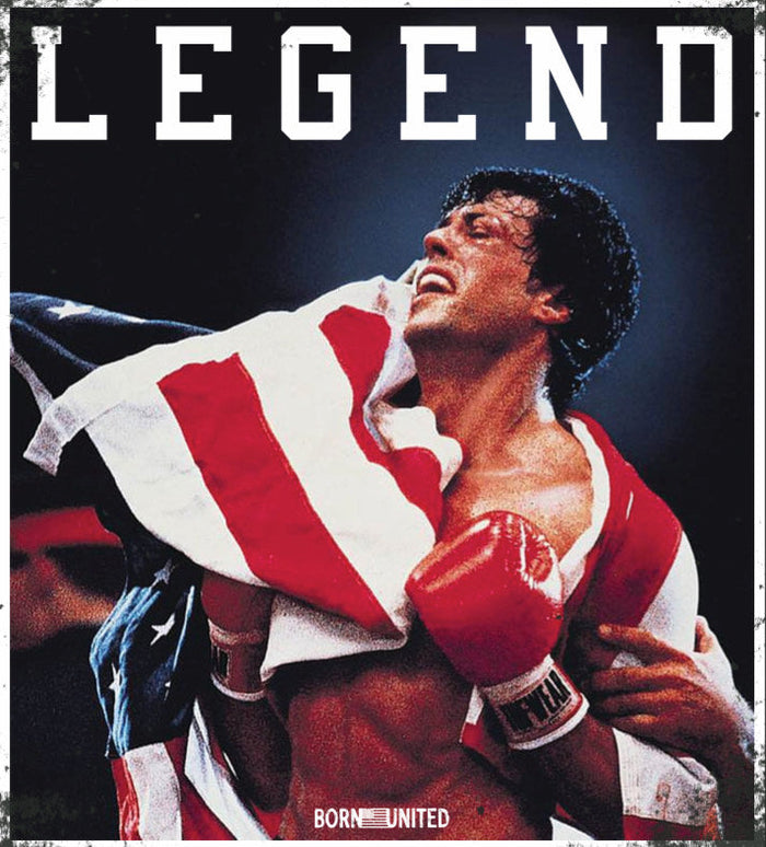 A victorious boxer draped in an American flag and red gloves smiles under the bold “LEGEND” text. This is featured on Born United Private Label’s Legend - Balboa PVC Patch.