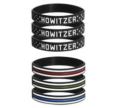 Two stacks of black rubber Support Military Bracelets by Howitzer Clothing: the top stack features four bracelets with white HOWITZER logos and stars; the bottom stack has four bands with white, red, green, and blue support stripes.